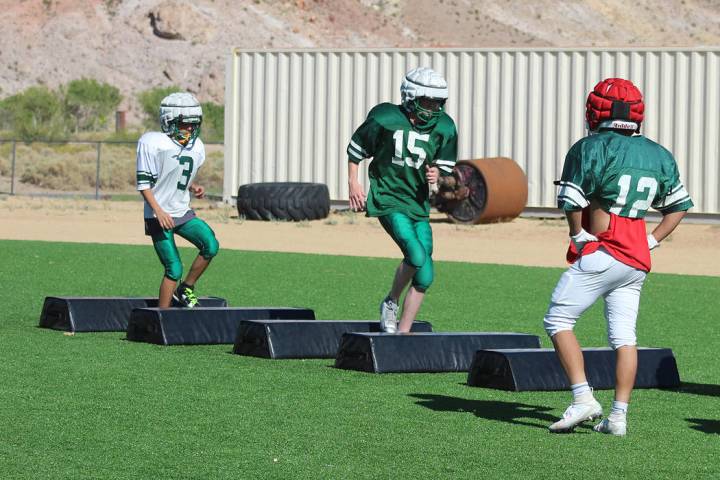 Tom Rysinski/Pahrump Valley Times Senior Fabian Perez, right, watches as two of his teammates c ...