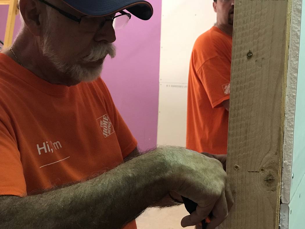 Jeffrey Meehan/Pahrump Valley Times Volunteers from Home Depot and the Nye County area assist i ...
