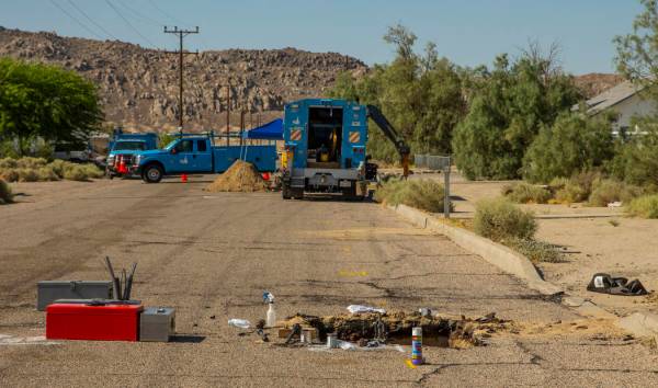 L.E. Baskow/Las Vegas Review-Journal An open hole revealing a broken gas line is repaired by a ...