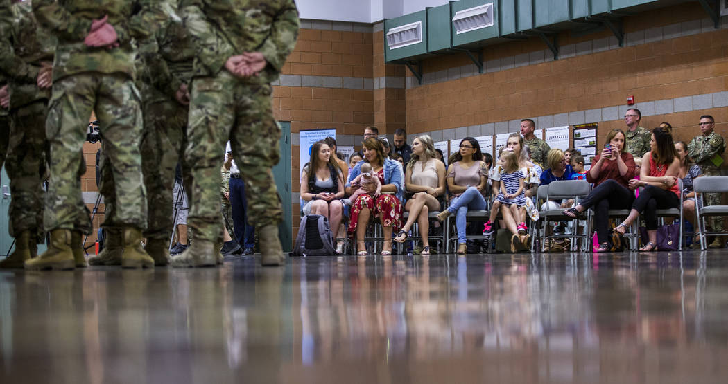 Families and friends look on as soldiers with the Nevada Army Guard 3665th Explosive Ordnance D ...