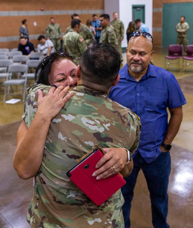 (From left) Maritza Pierluissi hugs her son Sgt. Ulises Pierluissi Jr. goodbye as his father Ul ...