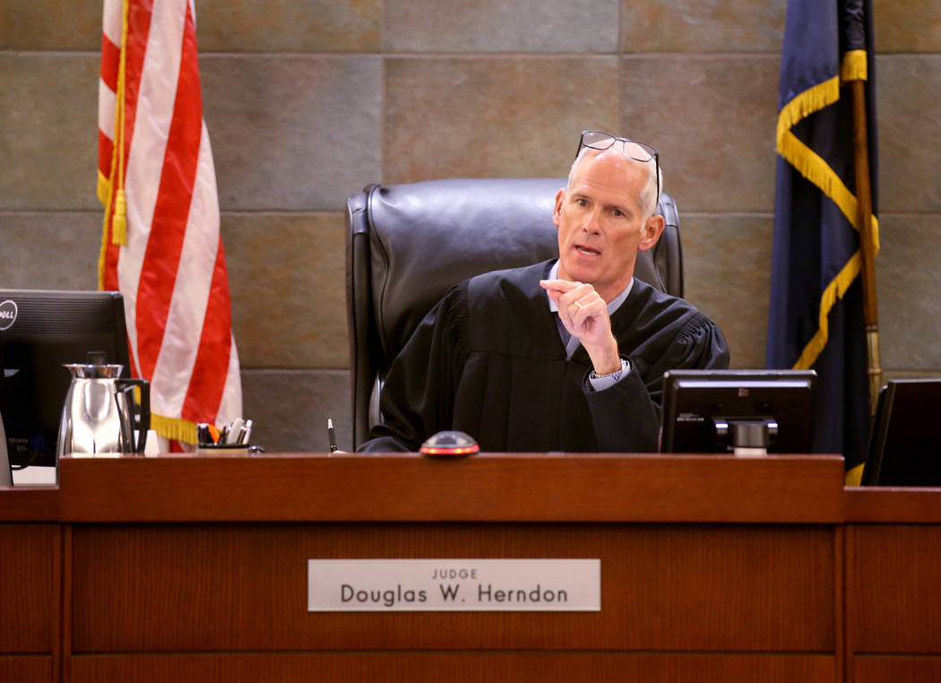 District Judge Douglas Herndon presides during the initial arraignment of some of the 23 people ...