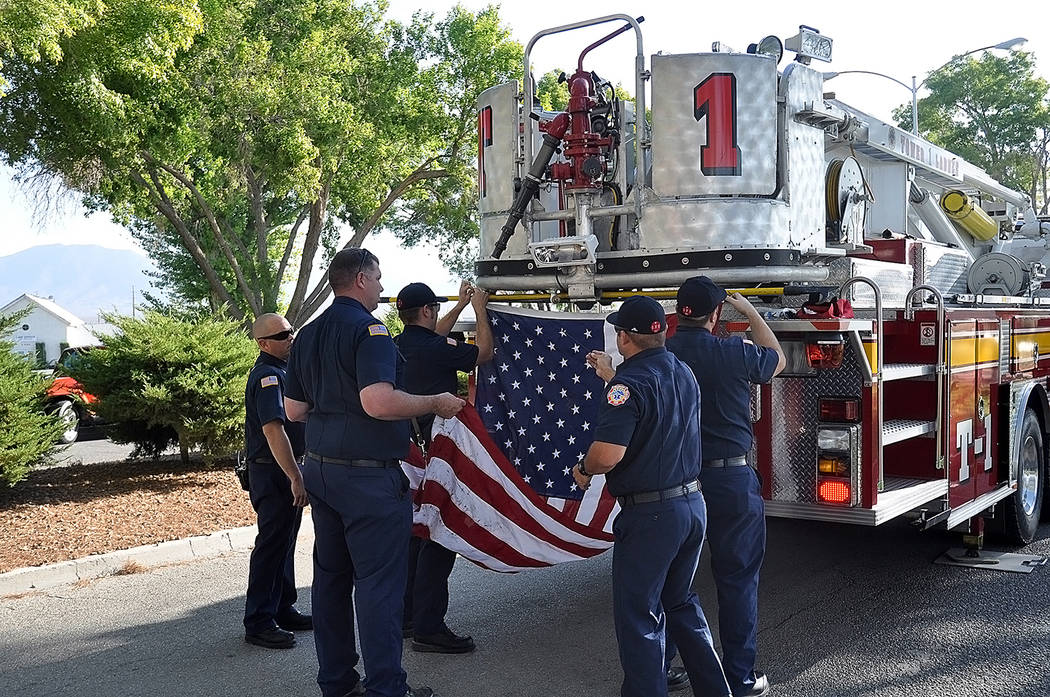 Horace Langford Jr./Pahrump Valley Times Pahrump firefighters and EMT's prepare to raise the A ...