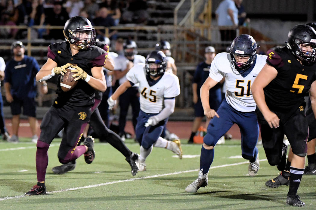 Peter Davis/Special to the Pahrump Valley Times Pahrump Valley junior Dylan Wright rolls out on ...