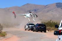 A Metropolitan Police Department helicopter lands near Goodsprings, southwest of Las Vegas, whe ...