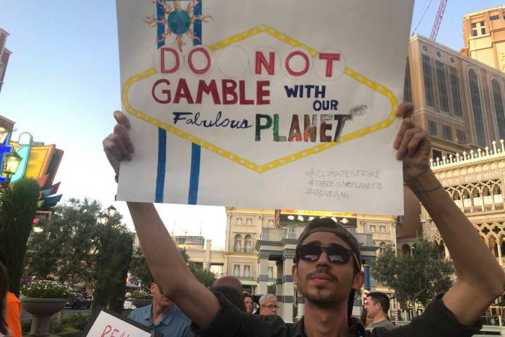 Katelyn Newberg/Las Vegas Review-Journal Israan Mendes, 24, holds a sign as more than 100 peopl ...