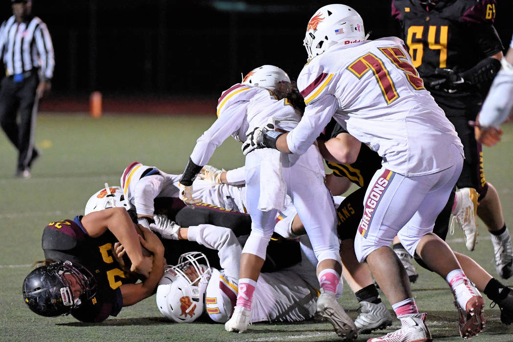 Peter Davis/Special to the Pahrump Valley Times Kenny Delker, shown getting tackled by several ...