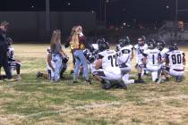 Tom Rysinski/Pahrump Valley Times Pahrump Valley High School football players take a knee while ...