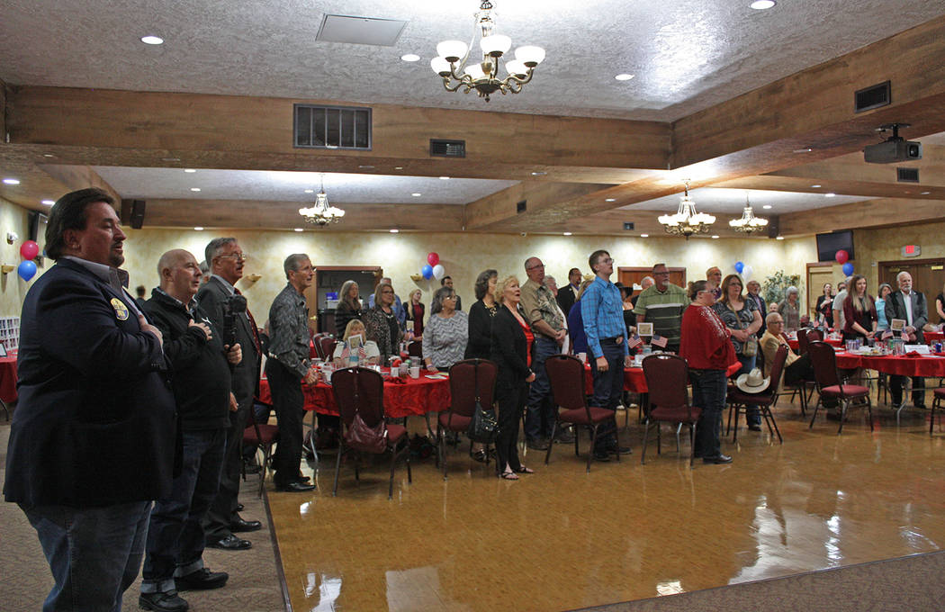 Robin Hebrock/Pahrump Valley Times Reagan Dinner attendees stand and place their hands over the ...