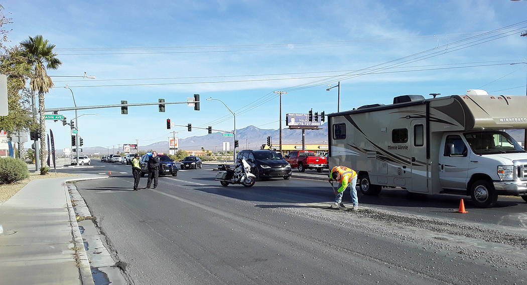 Selwyn Harris/Pahrump Valley Times Workers from a local concrete company clean up gravel after ...