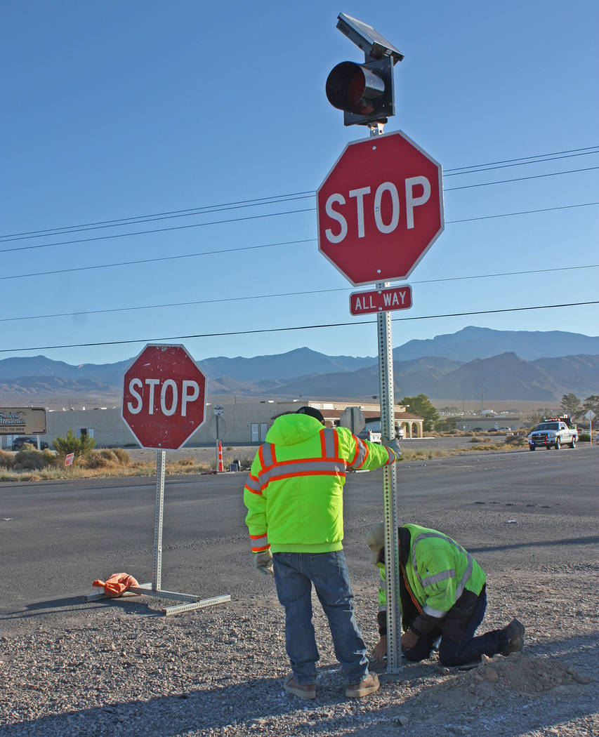 Robin Hebrock/Pahrump Valley Times Nye County Public Works road crews are pictured erecting a n ...