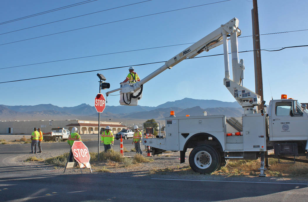 Robin Hebrock/Pahrump Valley Times While installing new stop signs on Calvada Boulevard, road c ...