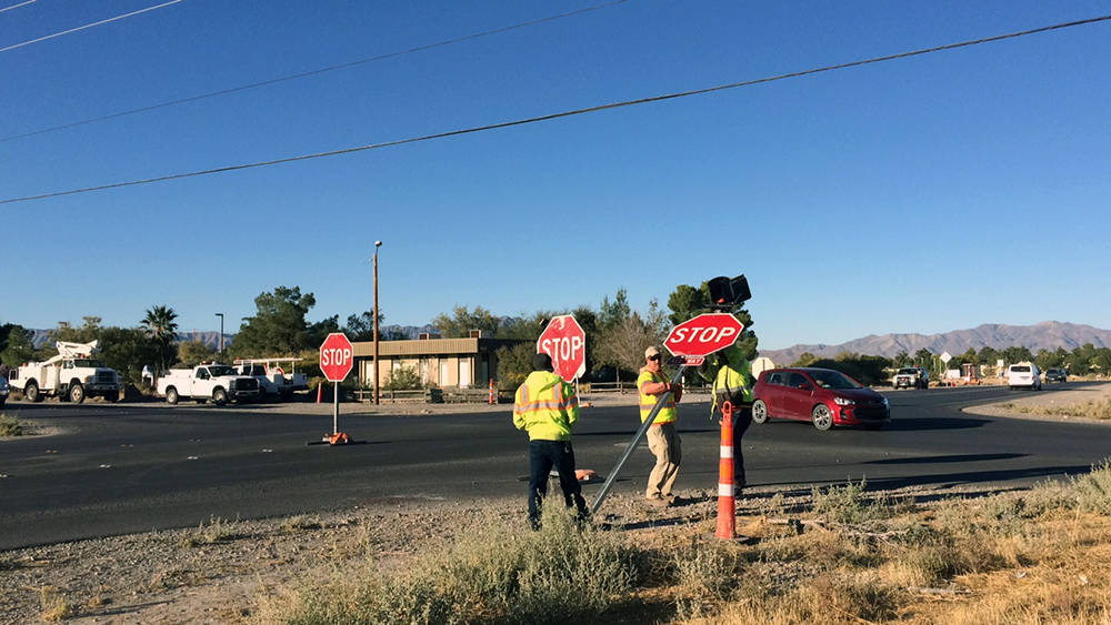 Robin Hebrock/Pahrump Valley Times Road crews are seen raising a new stop sign on Calvada Boule ...