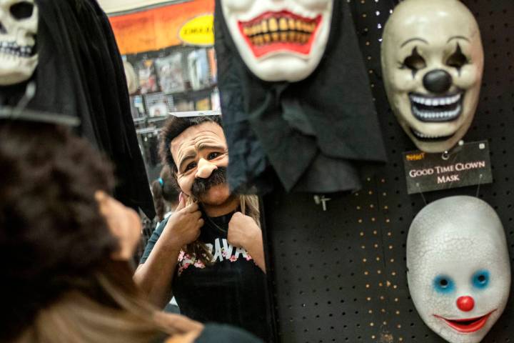 Ellen Schmidt/Las Vegas Review-Journal Laura Silva of St. George, Utah tries on a mask for her ...