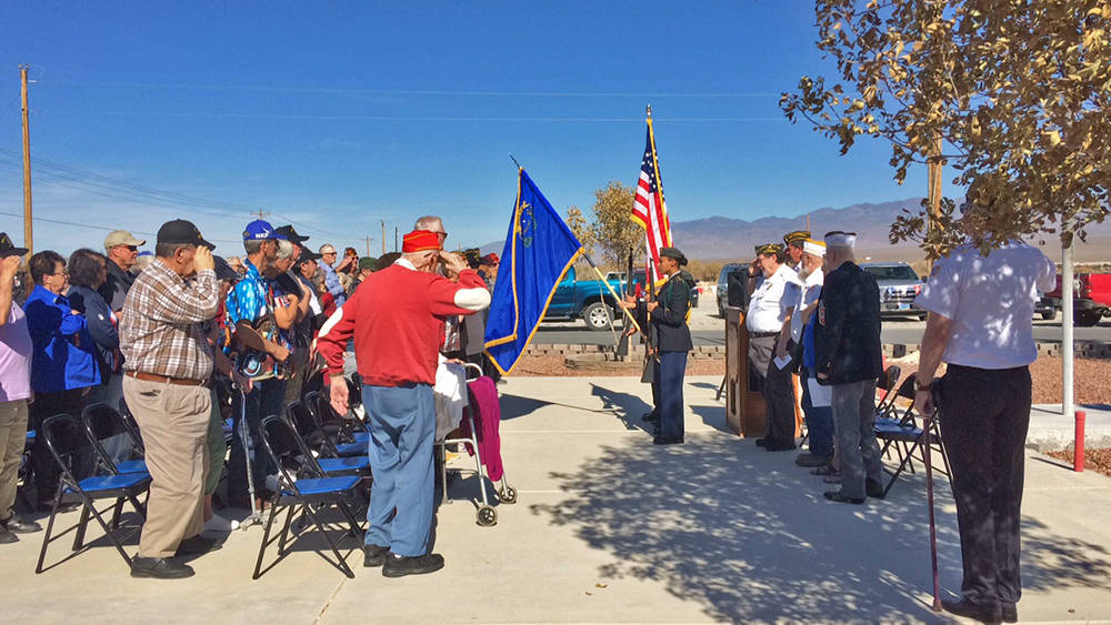 Robin Hebrock/Pahrump Valley Times A large crowd of attendees salute the flag as the Veterans o ...