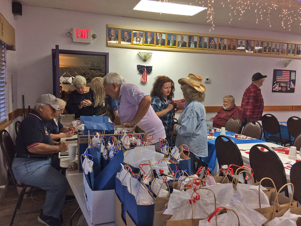 Robin Hebrock/Pahrump Valley Times Veterans are seen signing in for a dinner hosted in their ho ...