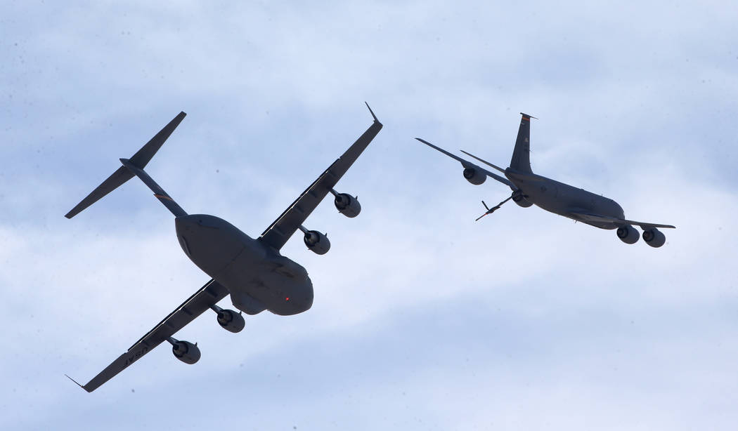 A KC-135, right, flies away from a C17 after demonstrating mid-air fueling at Aviation Nation 2 ...