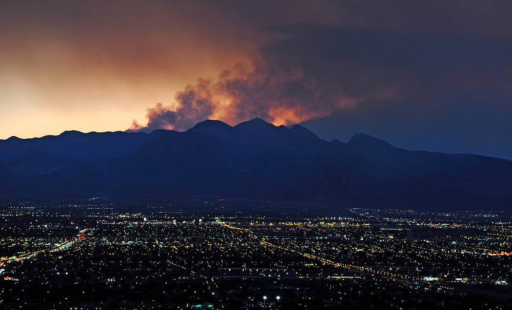 Smoke rises from the Carpenter 1 wildfire as the sun sets over Las Vegas on July 9, 2013. (Davi ...