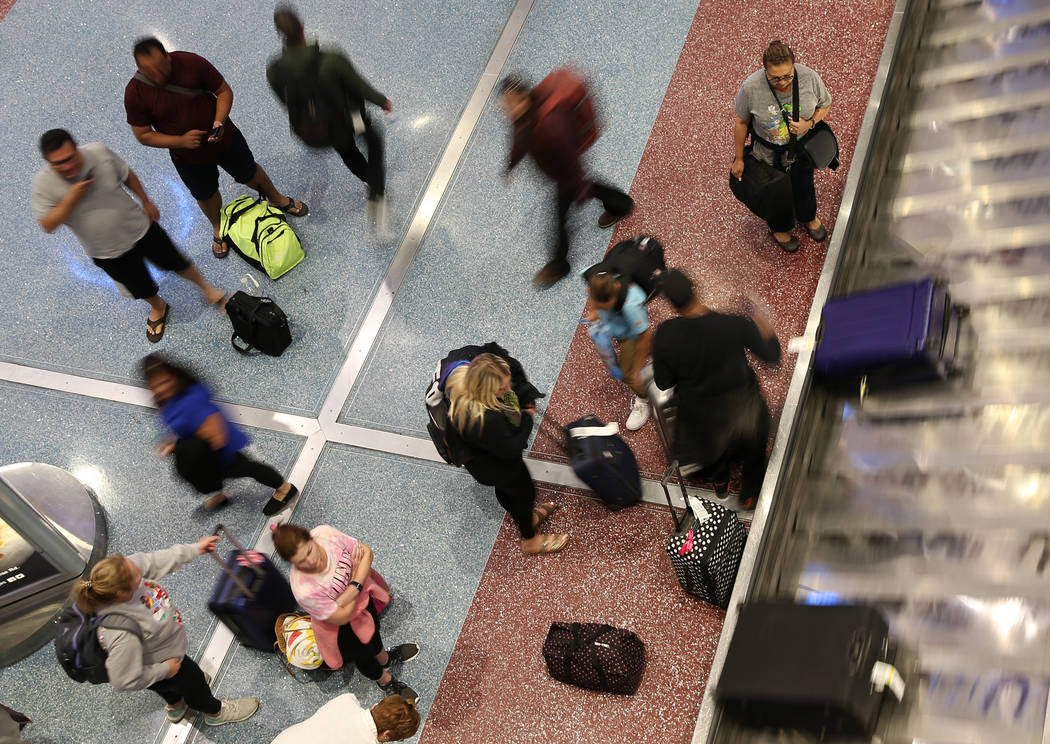Passengers at Terminal 1 baggage claim at McCarran International Airport in Las Vegas, Wednesda ...