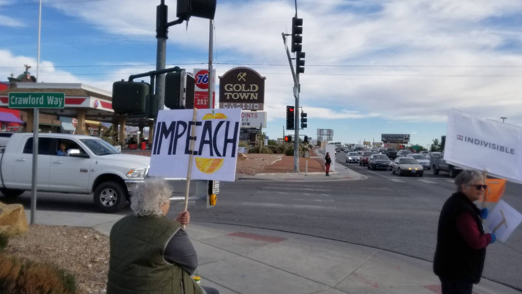 David Jacobs/Pahrump Valley Times Protesters opposing President Donald Trump are shown gatherin ...