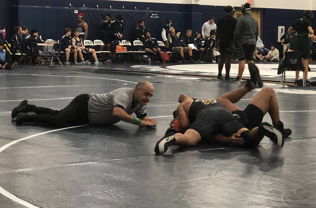 Tom Rysinski/Pahrump Valley Times The referee moves in to signal a fall for Pahrump Valley juni ...