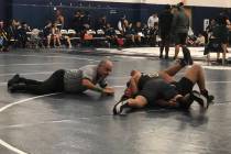 Tom Rysinski/Pahrump Valley Times The referee moves in to signal a fall for Pahrump Valley juni ...
