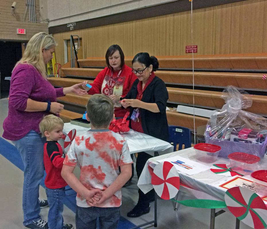 Robin Hebrock/Pahrump Valley Times A local family purchases a raffle ticket for the gift basket ...