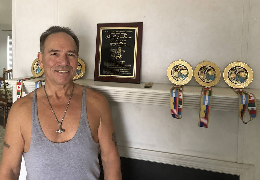 Tom Rysinski/Pahrump Valley Times Gary Miller with medals for his three most recent titles and ...