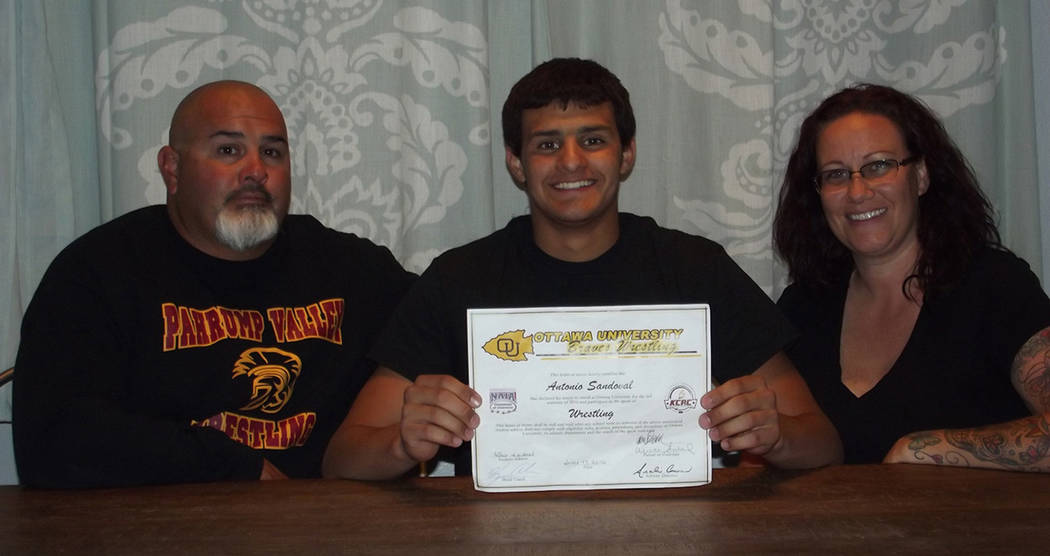 Pahrump Valley Times file photo Flanked by his parents, Antonio Sandoval displays his National ...