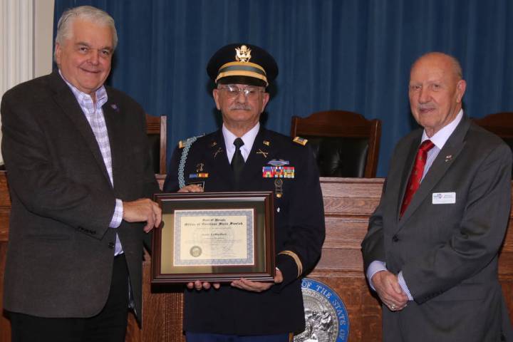 Steve Ranson/Nevada News Group Gov. Steve Sisolak, left, presents the December Veteran of the M ...