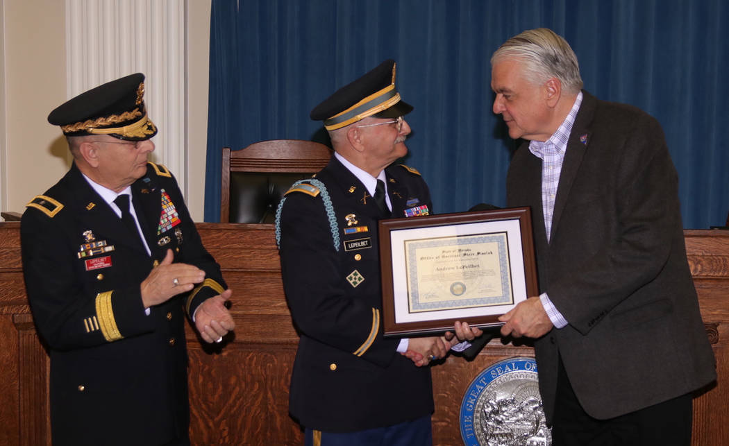 Steve Ranson/Nevada News Group Gov. Steve Sisolak, right, presents Army veteran Andrew LePeilbe ...