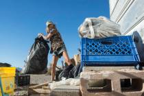 Homeless resident Mary Supples packs up her belongings laying outside of her trailer in prepara ...