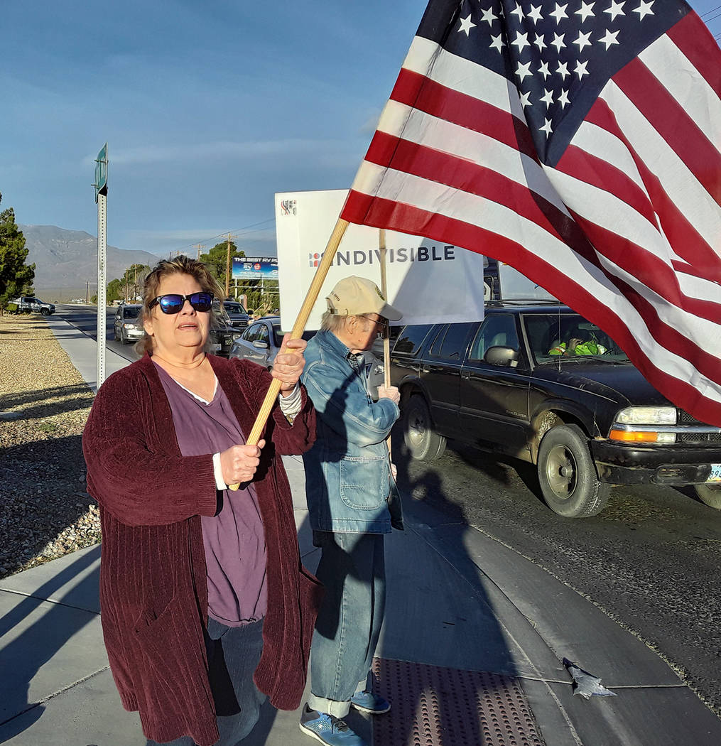 Selwyn Harris/Pahrump Valley Times While holding the American flag aloft, Pahrump resident DeDe ...