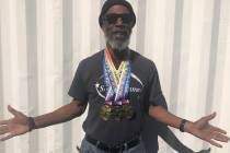 Tom Rysinski/Pahrump Valley Times Pahrump resident Marvin Caperton wears the three gold medals ...