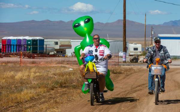 Eric Harvey, left, and Jason Webster of Orange County cruise around the parking area with alien ...