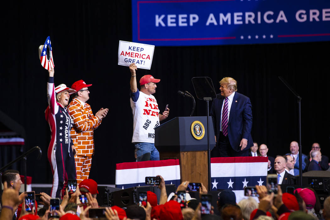 Chase Stevens/Las Vegas Review-Journal President Donald Trump welcomes supporters to the stage ...