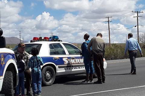 Selwyn Harris/Pahrump Valley Times A Nye County Sheriff's deputy, at left, comforts and plays w ...