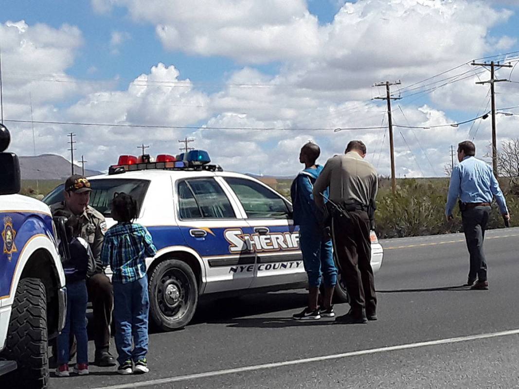 Selwyn Harris/Pahrump Valley Times A Nye County Sheriff's deputy, at left, comforts and plays w ...