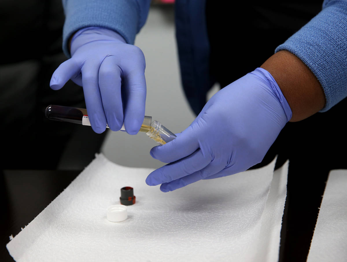 K.M. Cannon/Las Vegas Review-Journal Phlebotomist Dana Duncan, 37, separates serum from blood d ...