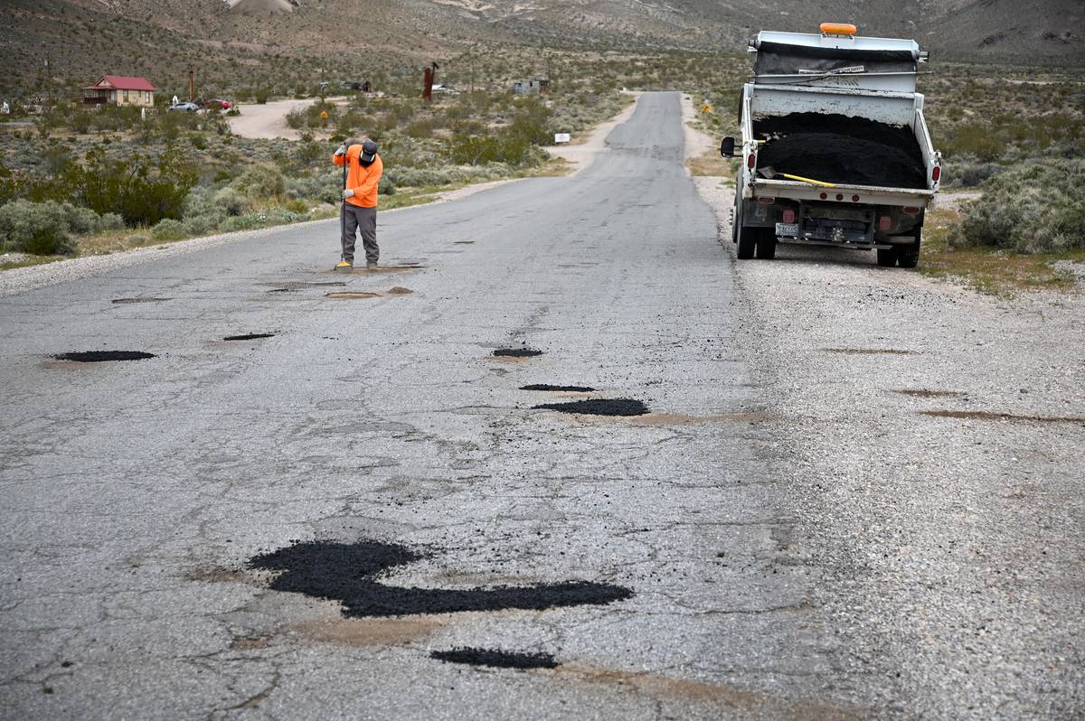 Richard Stephens/Special to the Pahrump Valley Times A road construction crewman works to patch ...