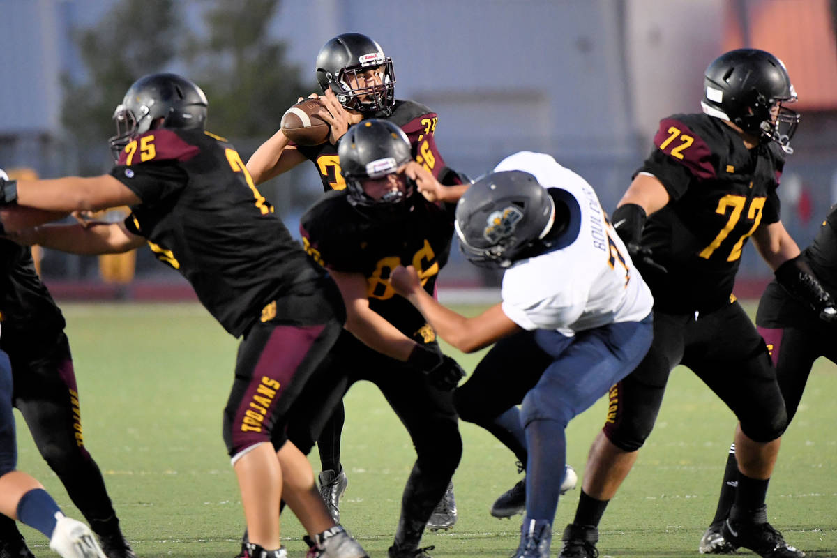 Peter Davis/Pahrump Valley Times PVHS quarterback Roman Roberts looks for a receiver during la ...