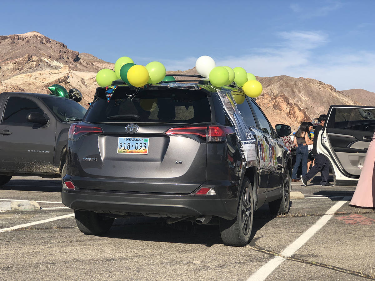Tom Rysinski/Pahrump Valley Times Green, gold and white balloons adorn the vehicle which carrie ...
