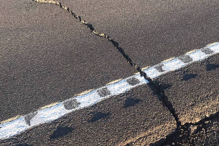 Nevada Department of Transportation Cracks in the pavement show some of the damage caused to U. ...