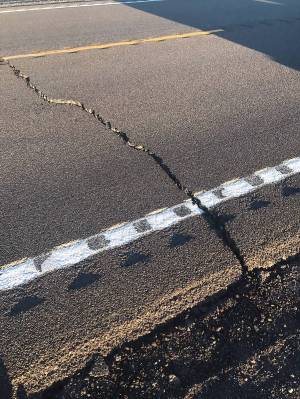Nevada Department of Transportation Cracks in the pavement show some of the damage caused to U. ...