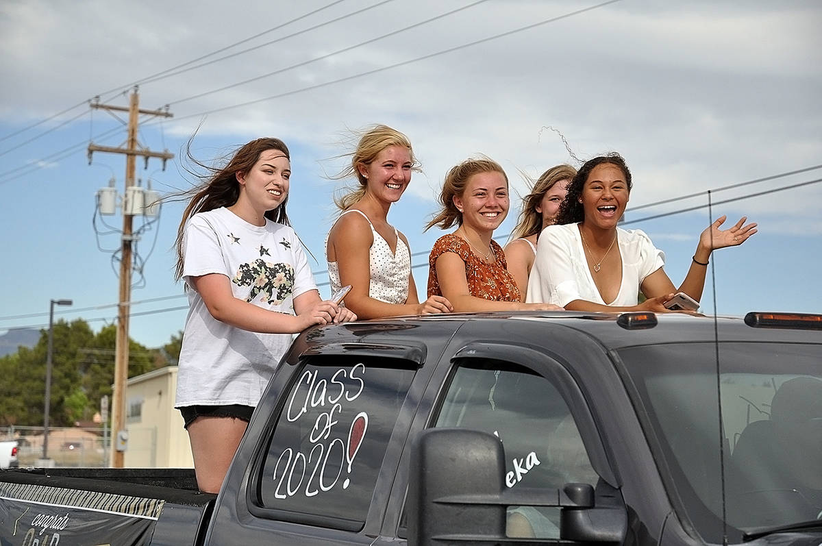 Horace Langford Jr./Pahrump Valley Times A group of PVHS 2020 graduates wave to onlookers duri ...