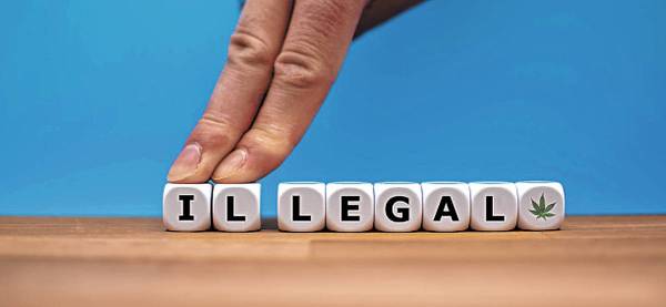 Symbol for Marijuana Legalization. Dice form the word "ILLEGAL" while two fingers pus ...
