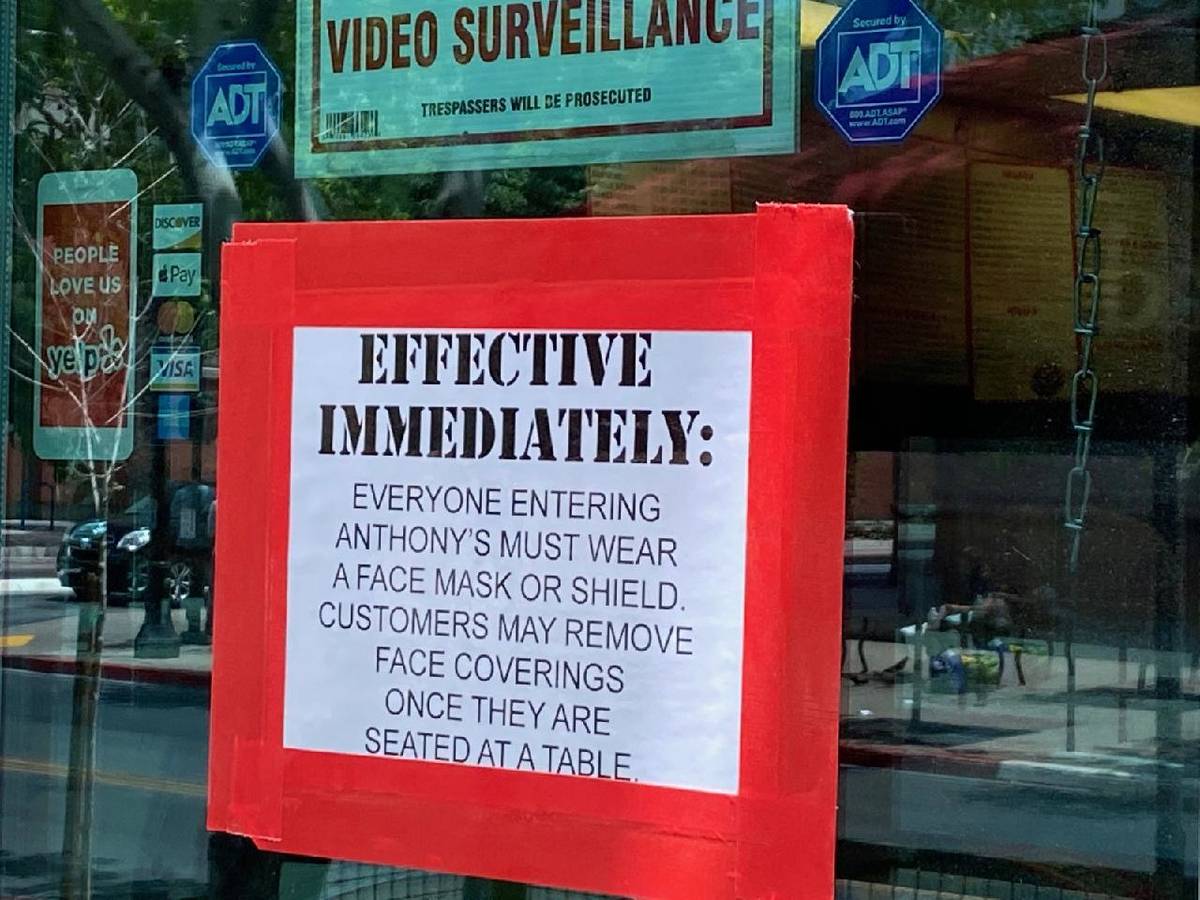 A sign at Anthony's in downtown Las Vegas reminds customers that face masks are required to ent ...