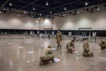 Elizabeth Brumley/Las Vegas Review-Journal The National Guard puts down 6-foot markers in prepa ...
