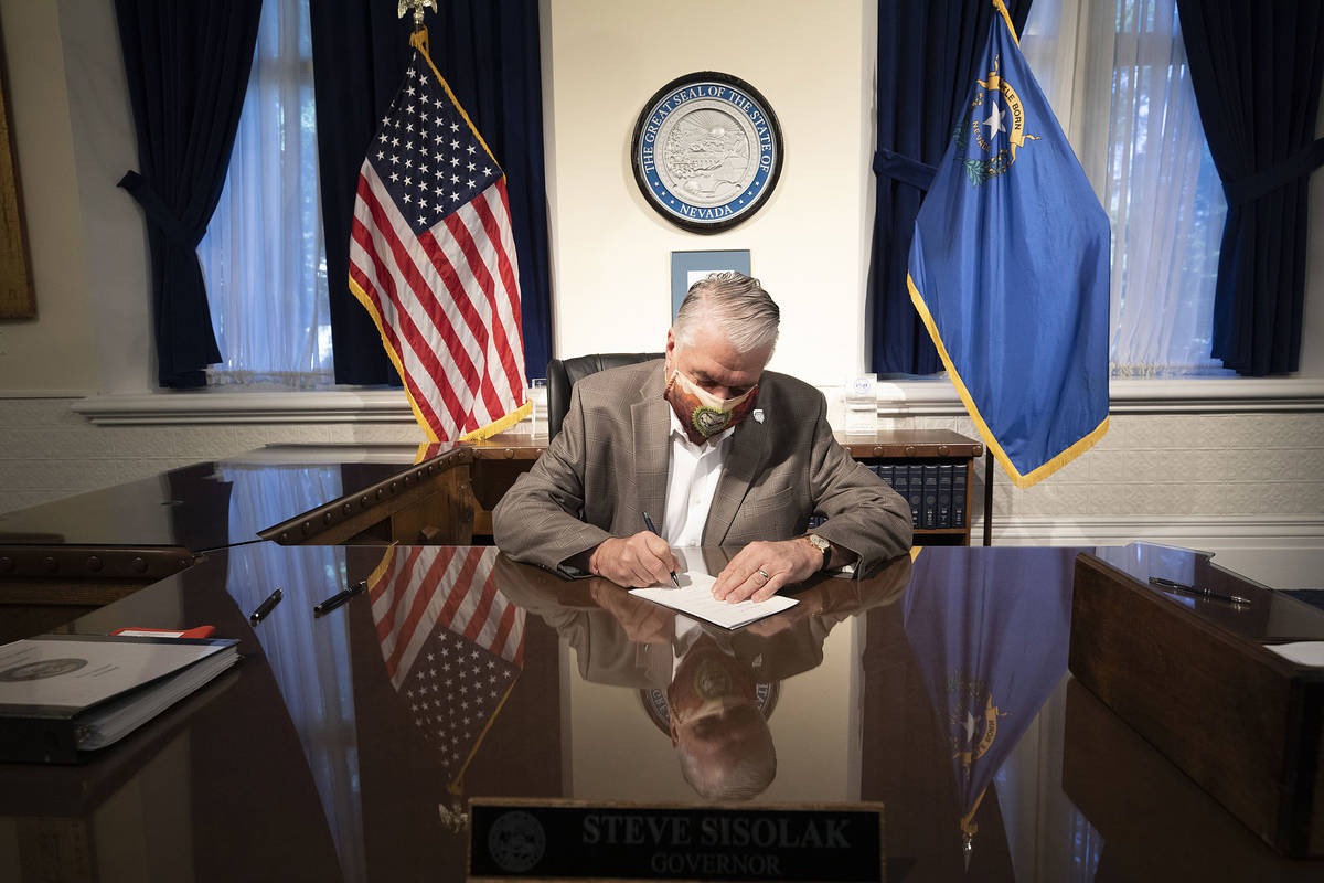 Special to the Pahrump Valley Times Gov. Steve Sisolak signs two pieces of criminal justice ref ...