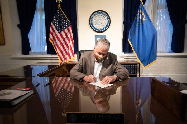 Special to the Pahrump Valley Times Gov. Steve Sisolak signs two pieces of criminal justice ref ...